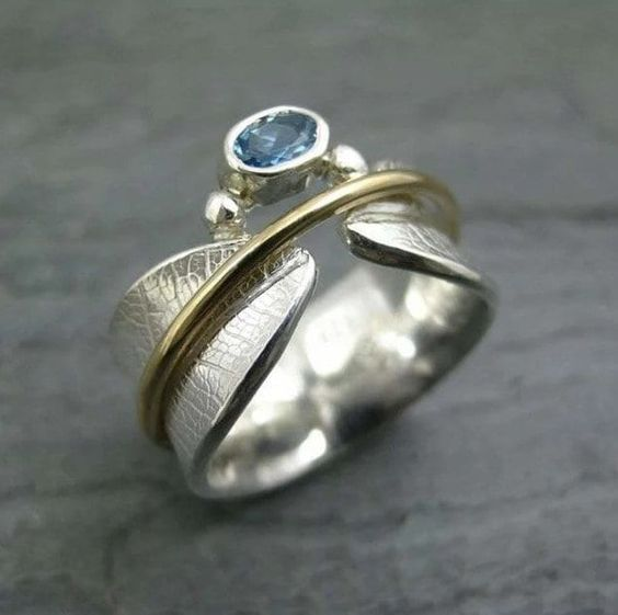 Open ring with blue crystal in